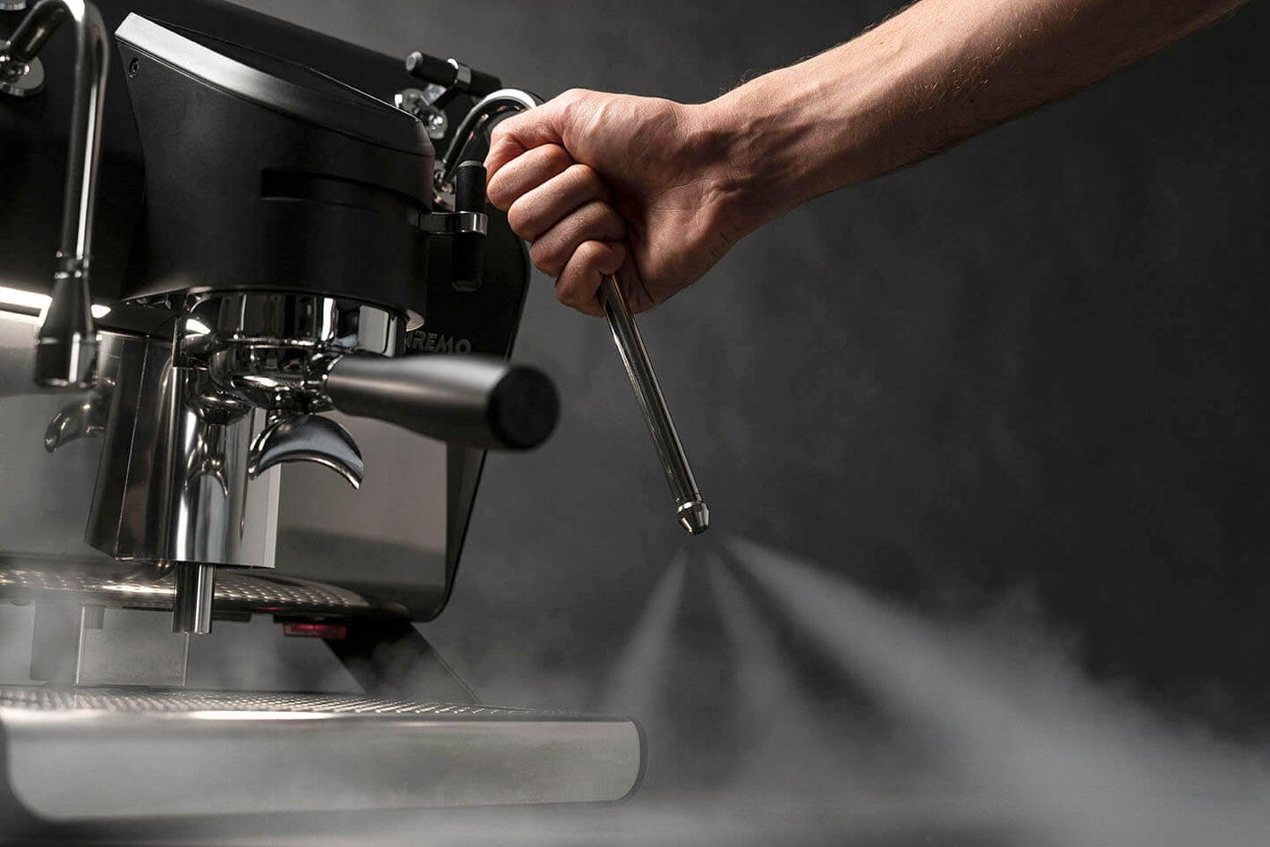 Close-up of the Sanremo YOU espresso machine’s cool-touch steam wand in action, releasing steam safely — perfect for home baristas and small café owners seeking professional control with comfort.